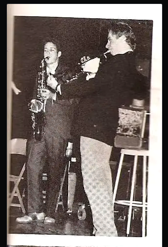 Black-and-white photograph of a young Jesse Kulp playing saxophone beside an older musician.